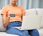 Black woman on sofa, laptop and credit card for finance, budget and check investments in lounge. Computer, female and girl in living room, online banking and transactions for payments and ecommerce