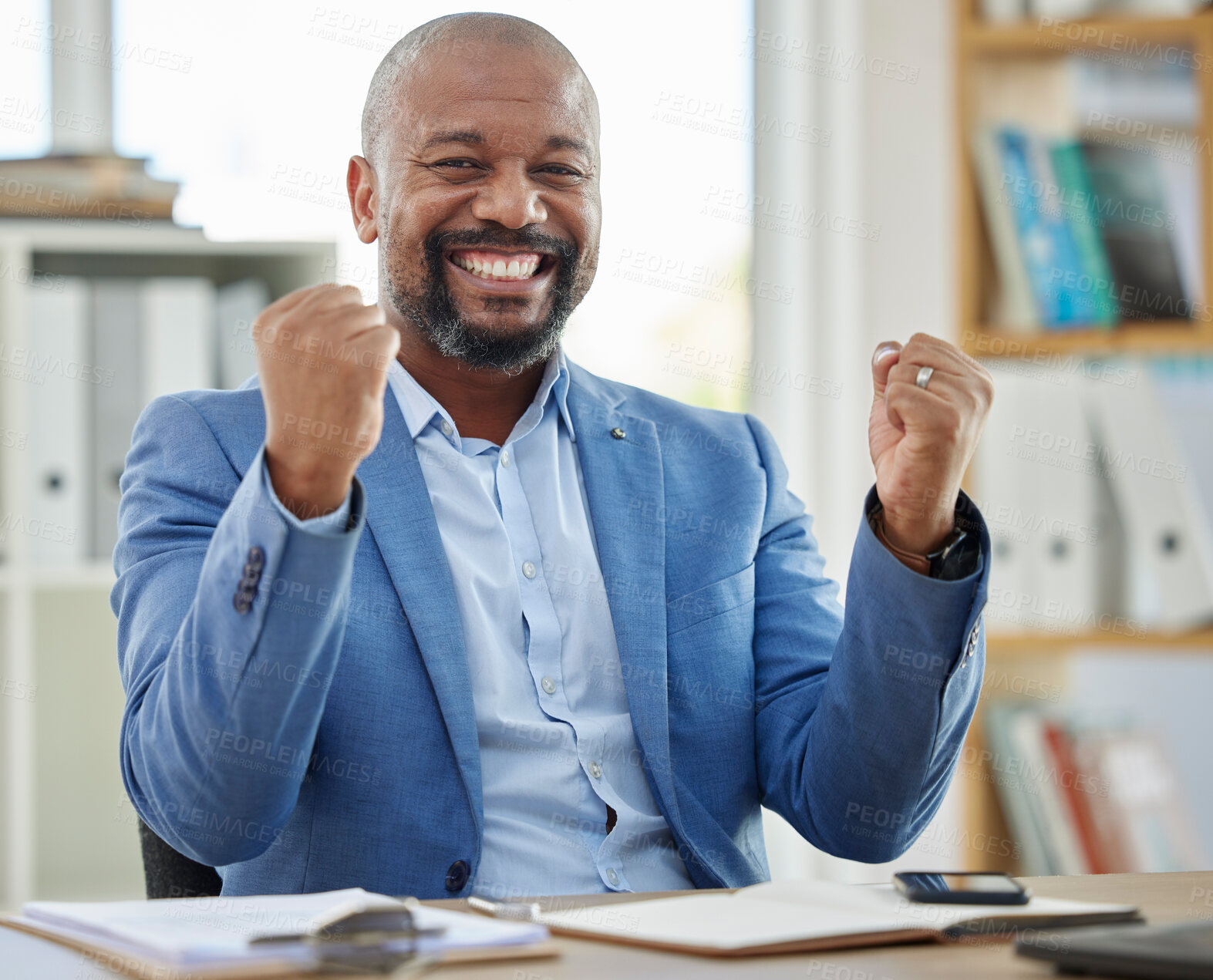 Buy stock photo Success, winner and businessman at his desk in office for company profit, stock market or financial increase, promotion or bonus. Happy news, fist and winner corporate black man in a career portrait