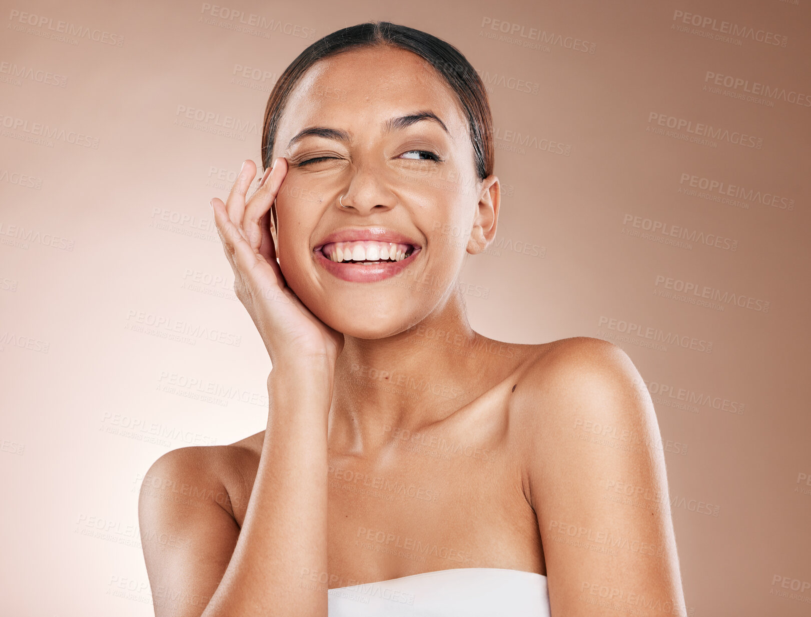 Buy stock photo Skincare, beauty and happiness, portrait of woman with smile laughing on studio background. Makeup, glamour and wink, luxury skin care with hands on face, natural detox facial massage on happy woman
