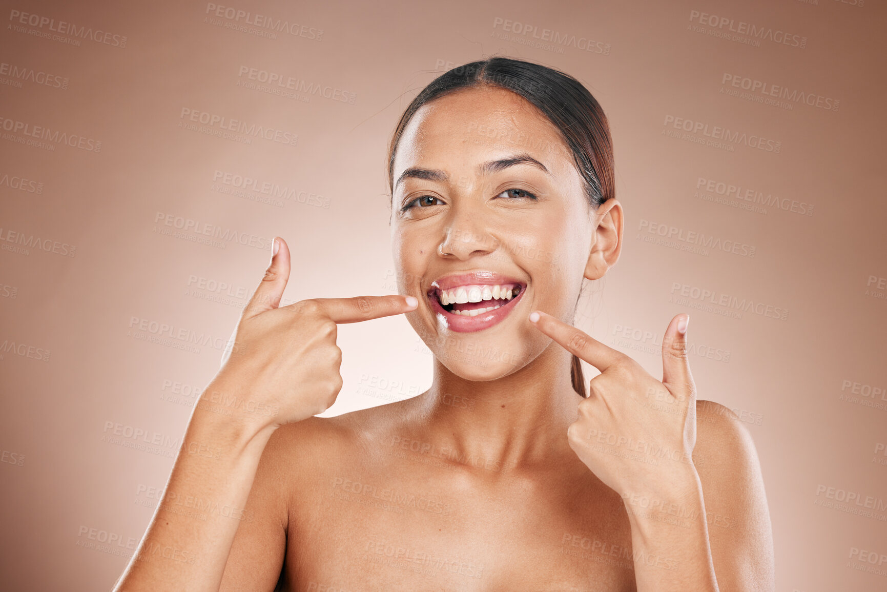 Buy stock photo Dental, portrait and woman pointing to teeth on studio background for wellness, aesthetic beauty or cosmetics. Model face showing healthy smile, clean mouth and fresh breath from happy oral results