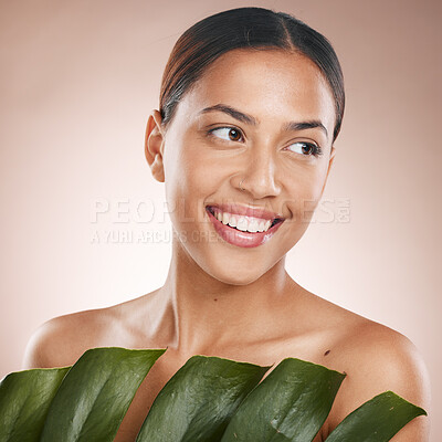 Buy stock photo Woman, face skincare and monstera leaf on pink studio background for organic dermatology, self love or healthcare wellness. Happy, smile or beauty model with green plant, natural makeup or cosmetics