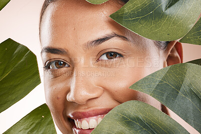 Buy stock photo Woman, closeup face and leaves in portrait for beauty, cosmetic wellness and smile, face glow and makeup. Model, skin health and facial cosmetics, self care and aesthetic with monstera by backdrop