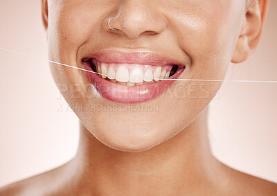 Buy stock photo Floss, woman and smile with dental care, clean mouth and after brushing teeth against studio background. Oral health, Latino female and girl with string, fresh breath and morning routine for hygiene