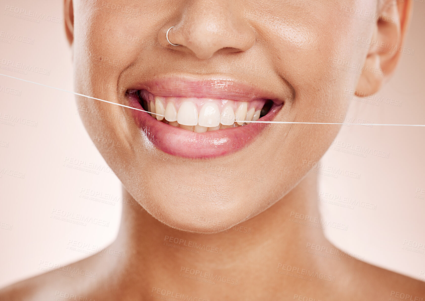 Buy stock photo Floss, woman and smile with dental care, clean mouth and after brushing teeth against studio background. Oral health, Latino female and girl with string, fresh breath and morning routine for hygiene