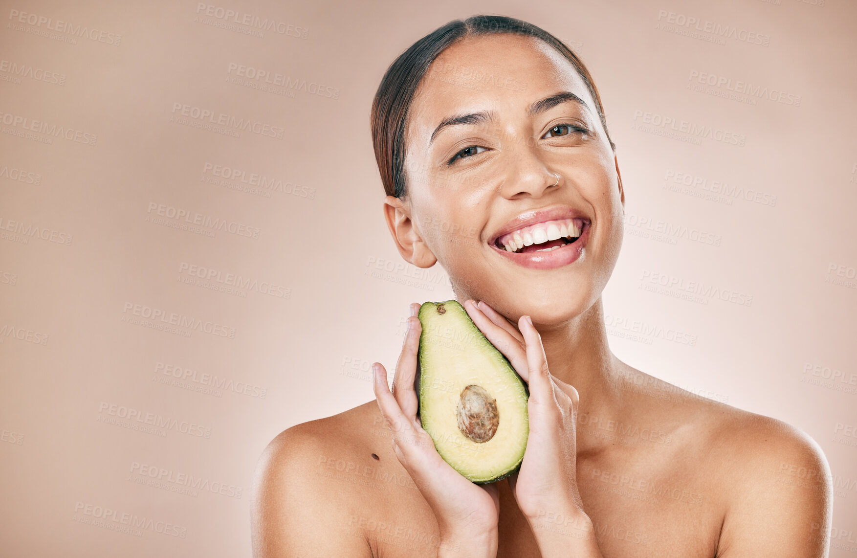 Buy stock photo Skincare, beauty and portrait of woman with avocado on brown background for wellness, cosmetics and detox. Luxury spa, aesthetic and face of girl for organic, natural and healthy facial treatment