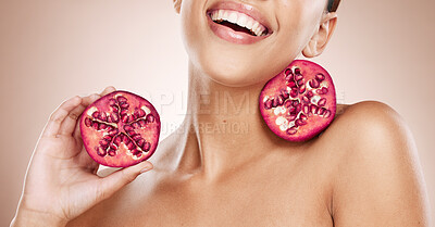 Buy stock photo Beauty, pomegranate and skincare with woman, natural product for healthy skin, wellness and cosmetic care. Happy glow, shine with vegan cosmetics and fruit for facial treatment with studio background