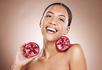 Portrait, woman and pomegranate with natural product for skincare, healthy skin and cosmetic care wellness. Glow, shine and smile, vegan cosmetics and fruit facial treatment with studio background