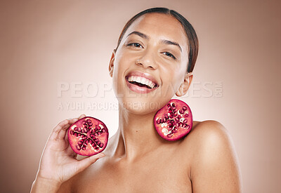 Buy stock photo Portrait, woman and pomegranate with natural product for skincare, healthy skin and cosmetic care wellness. Glow, shine and smile, vegan cosmetics and fruit facial treatment with studio background