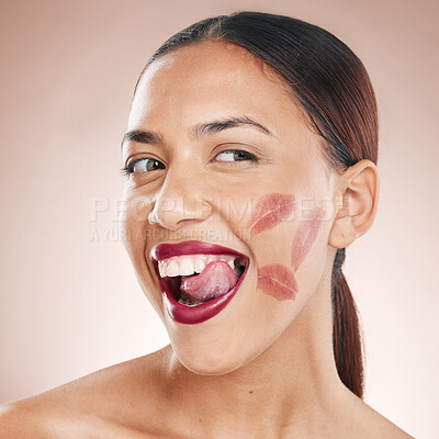 Buy stock photo Beauty, makeup and lipstick on a happy woman with tongue on teeth for cosmetics mockup on a studio background. Face of aesthetic model with a smile, glow and color on healthy skin with dermatology