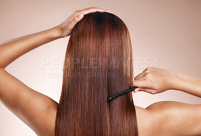 Buy stock photo Hair, salon and back of woman with comb for hair care, hair products and cosmetics on beige background studio. Beauty, hairdresser and girl with healthy long hair for hair salon, treatment and shine