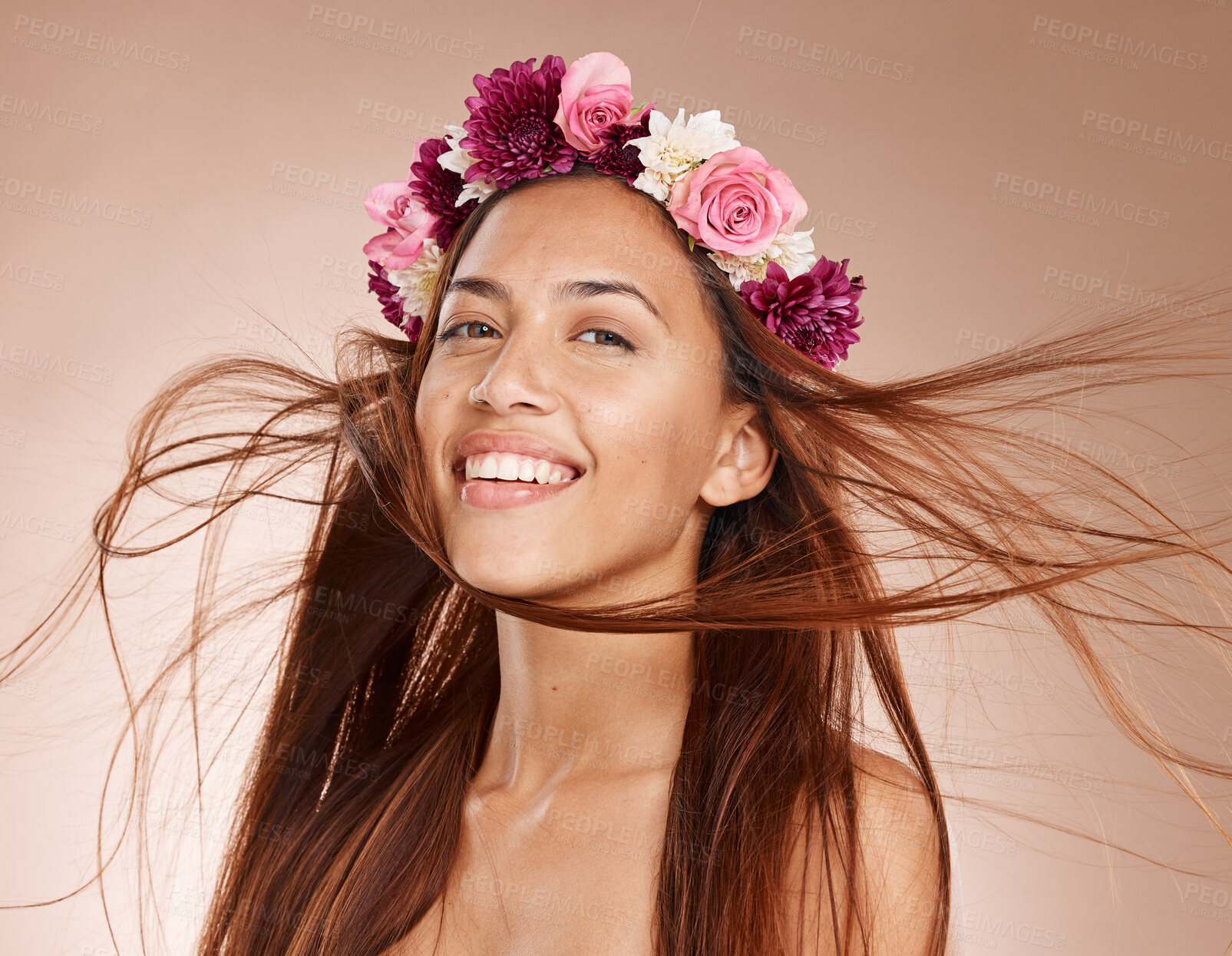 Buy stock photo Woman, portrait and flowers on crown, studio background and windy hair for healthy skincare in Brazil. Happy face, floral headband and model of beauty, spring fashion and natural makeup of eco plants