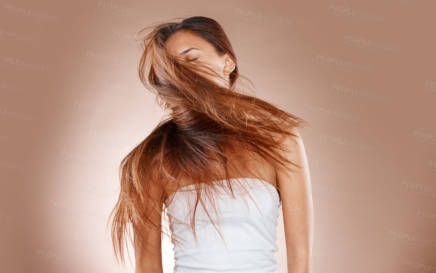 Buy stock photo Hair care, beauty and cosmetics of a woman shaking her head on studio background for luxury keratin treatment. Headshot of aesthetic model posing for salon, luxury hairdresser and wellness mockup