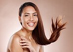 Face portrait, beauty skincare and woman in studio on a brown background. Hair care, makeup cosmetics and happy female model satisfied after salon treatment for healthy growth, texture or balayage.