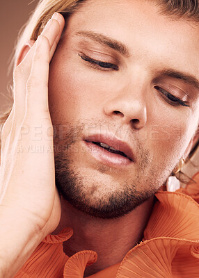 Buy stock photo LGBTQ, beauty fashion and face of model, transgender or non binary person with natural makeup, skincare or facial cosmetics. LGBT, orange clothes and creative gay man on studio background