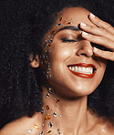 Woman, face or fashion body rhinestones on black background studio in jewels sparkle, festival diamonds or creative party crystal. Zoom, hand or happy afro beauty model, skin gem or makeup cosmetics