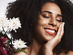 Makeup, flowers and happy black woman with skincare satisfaction and glowing texture routine. Aesthetic, health and wellness of confident cosmetics model with beautiful smile in white studio. 

