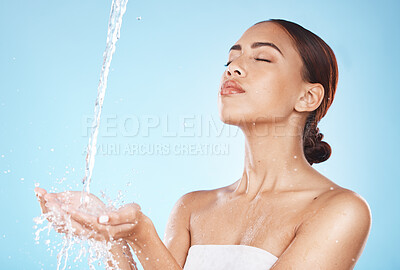 Buy stock photo Skincare, beauty and woman with water in hands for luxury facial cleaning and morning routine in studio. Water splash, spa product placement and relax, black woman with skin care on blue background.