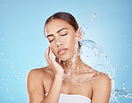 Woman hand, water splash or face skincare on blue background studio in healthcare wellness, relax hygiene or dermatology grooming. Beauty model, wet shower or water drop in facial cleaning or touch
