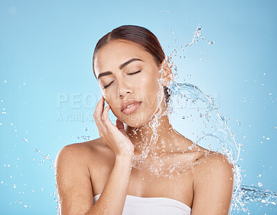 Buy stock photo Woman hand, water splash or face skincare on blue background studio in healthcare wellness, relax hygiene or dermatology grooming. Beauty model, wet shower or water drop in facial cleaning or touch