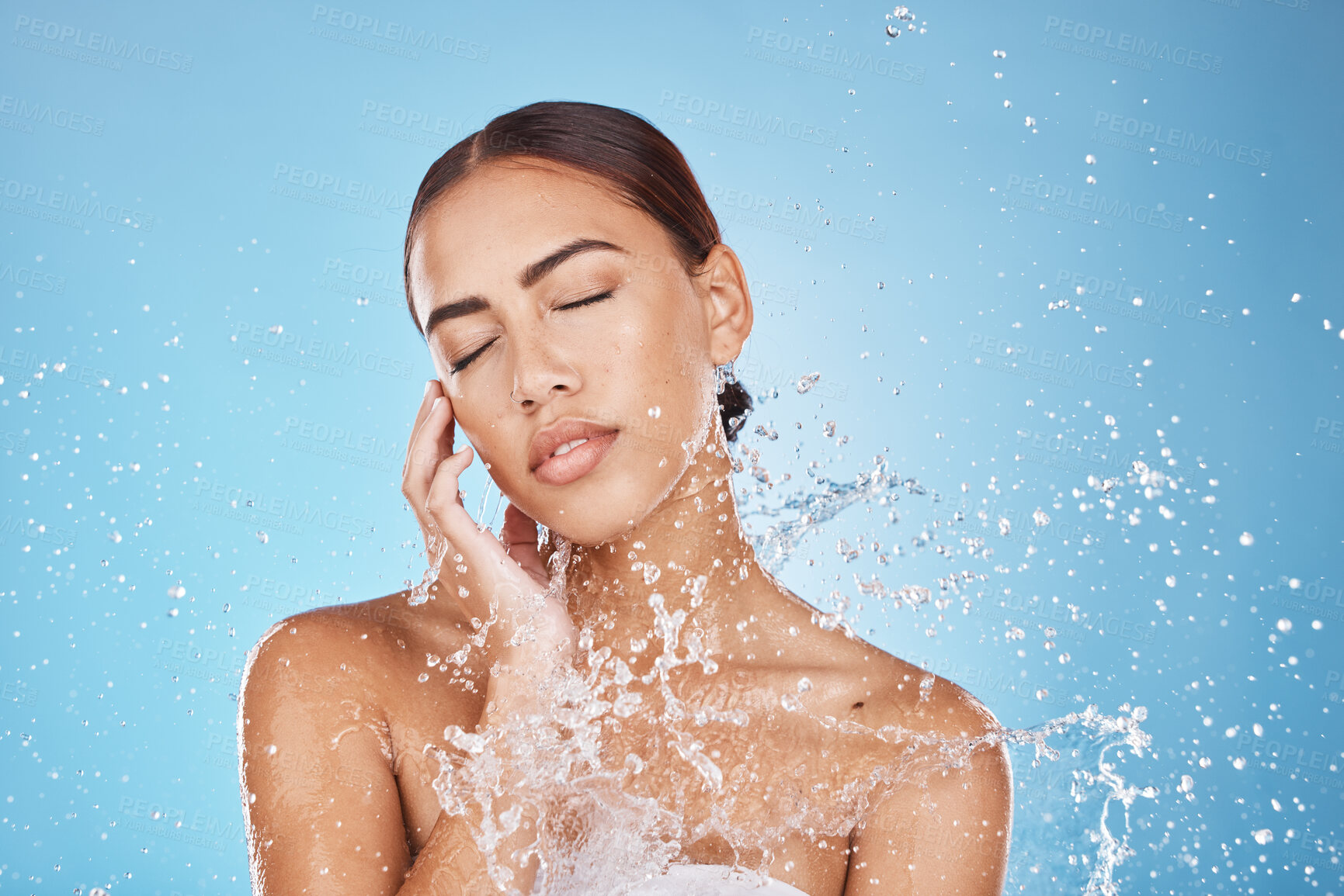 Buy stock photo Woman skincare, hand or water splash face on blue background studio in healthcare wellness, Brazil hygiene maintenance or bathroom grooming. Beauty model, shower or wet water drop for facial cleaning