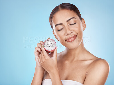 Buy stock photo Skincare, nutrition and woman with a dragon fruit for beauty, body health and cosmetic diet on a blue background in studio. Detox food, marketing and model advertising a fruit for healthy skin