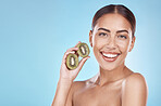 Skincare, kiwi and portrait of beauty woman with natural smile and healthy glow for marketing. Wellness, happy and self care model with fruit for cosmetic advertising in blue studio mockup.

