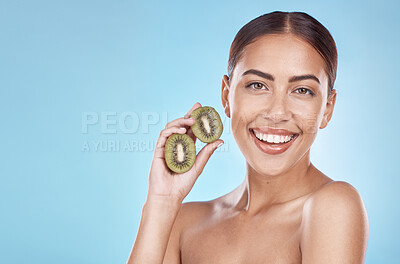 Buy stock photo Skincare, kiwi and portrait of beauty woman with natural smile and healthy glow for marketing. Wellness, happy and self care model with fruit for cosmetic advertising in blue studio mockup.

