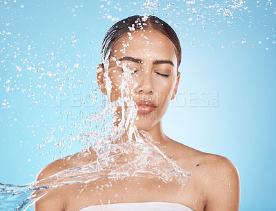 Buy stock photo Woman face, skincare grooming or water splash on blue background studio in dermatology wellness, healthcare cleaning or Brazil hygiene maintenance. Beauty model, wet or water drop for facial cleaning