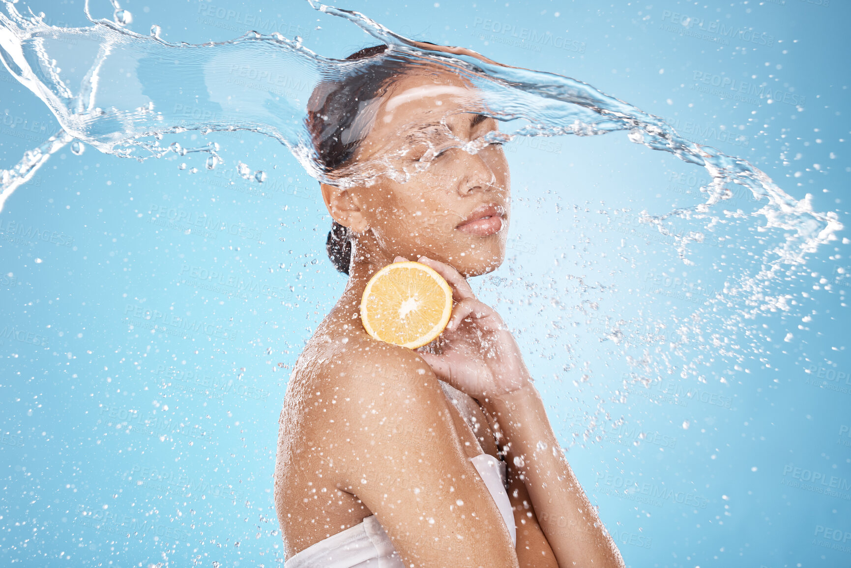 Buy stock photo Beauty, water splash and woman with a lemon for skincare, wellness and health with a face routine in a studio. Cosmetic, healthy and female model with a citrus fruit for a natural facial treatment.