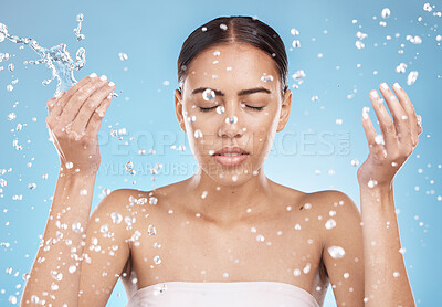 Buy stock photo Woman skincare, washing face or water splash on blue background studio for dermatology wellness, healthcare hygiene maintenance or grooming. Beauty model, hands or wet water drops for facial cleaning