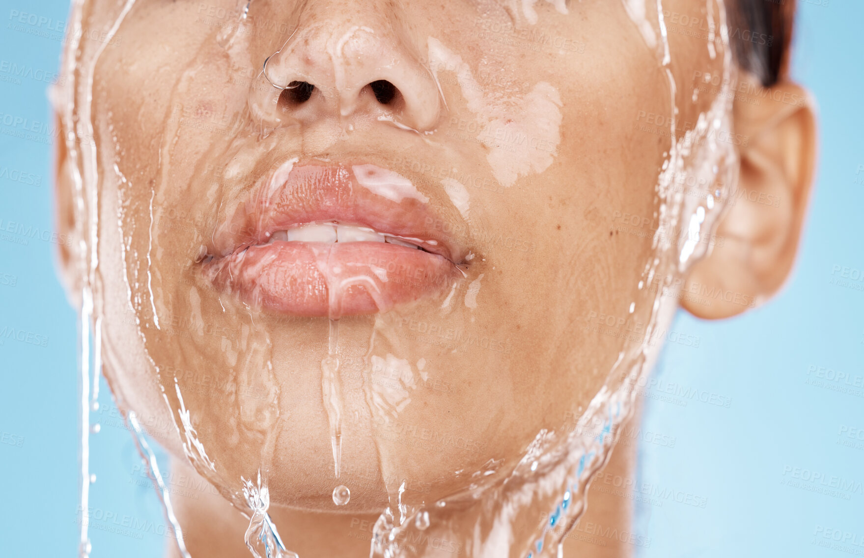 Buy stock photo Woman, washing face or water drops skincare on blue background studio in lips healthcare wellness, hygiene cleaning or mouth moisture grooming. Zoom, beauty model or facial water splash in wet shower