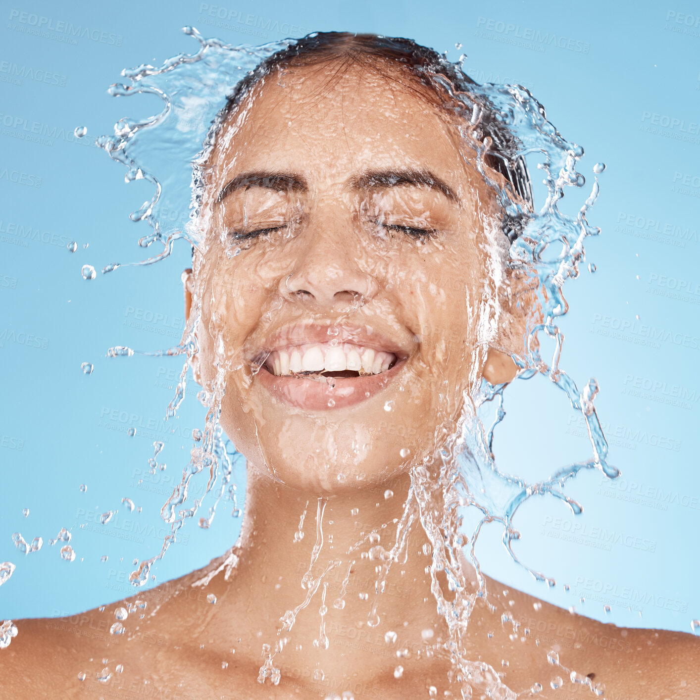 Buy stock photo Laughing woman, washing face or water splash skincare in relax healthcare wellness or grooming hygiene cleaning on blue background studio. Smile, beauty model or wet water drops in facial dermatology