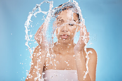 Buy stock photo Woman, hands and water splash for washing face grooming, healthcare wellness or self care hygiene on studio blue background. Beauty model, water drops cleaning and facial skincare in Brazil bathroom 