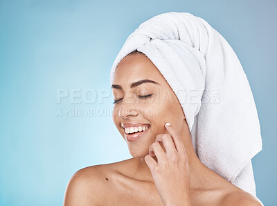 Buy stock photo Woman, face and happy skincare with towel for luxury beauty, salon spa cleaning and closed eyes in blue background studio. Happy model, smile and skin glow, facial wellness or hair care dermatology