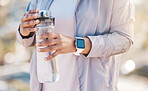 Water bottle, runner hands and outdoor fitness for training workout hydration, exercise rest and sports wellness. Athlete, running break and drinking water for morning cardio routine in nature park