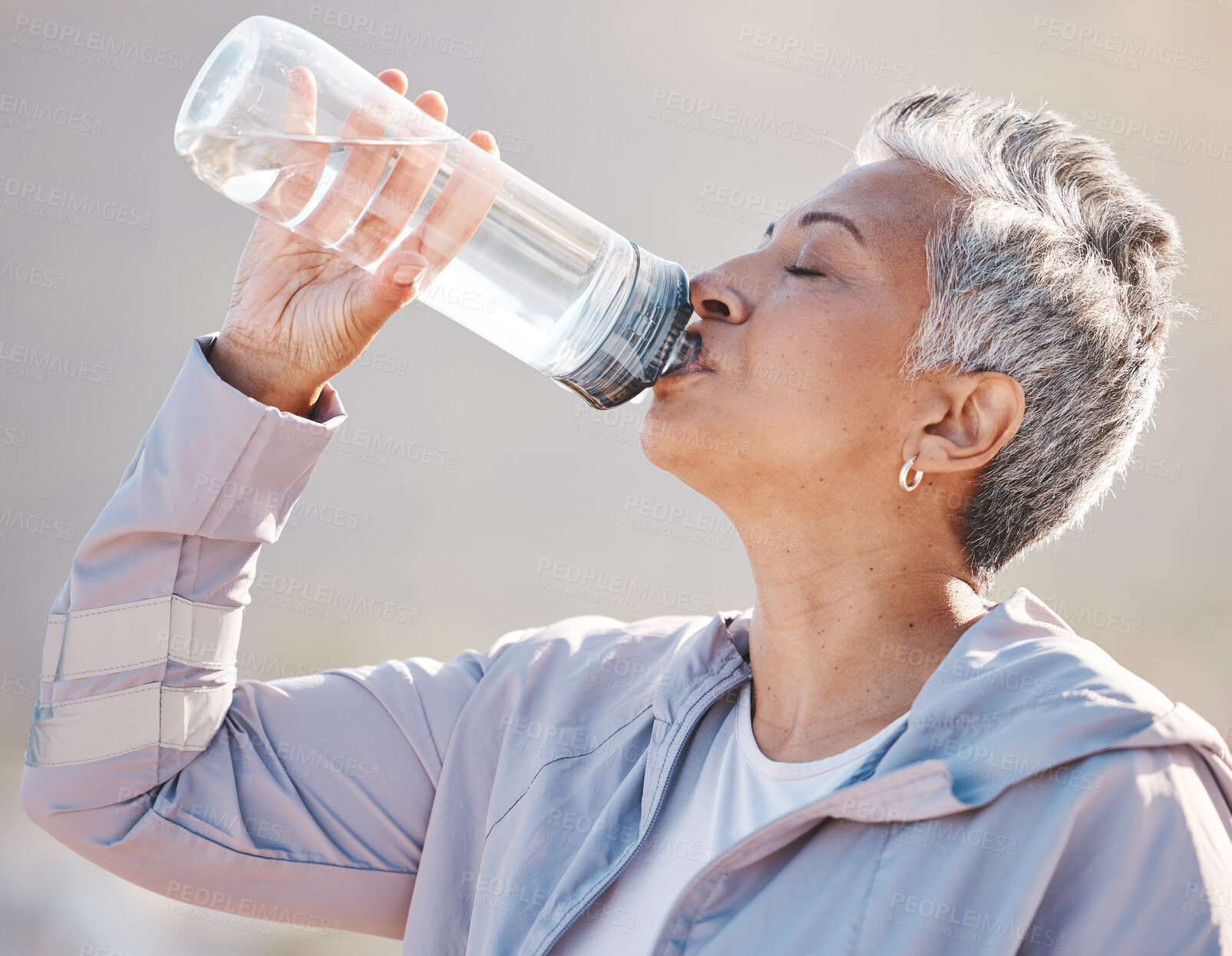 Buy stock photo Fitness, wellness and senior runner drinking water for hydration on outdoor run, marathon training or cardio workout. Sports exercise, bottle and profile of thirsty woman running in Miami Florida USA