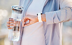 Water bottle, fitness and smartwatch with woman runner outdoor, cardio and wellness with time or steps progress check. Hand, smart watch and training, workout and running with wellness and sport