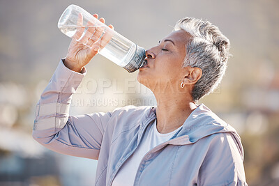 Buy stock photo Fitness, health and senior woman drinking water for hydration on outdoor cardio run, exercise or retirement workout. Marathon training, bottle and profile of runner running in Rio de Janeiro Brazil