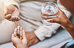 Hands of nurse with patient for pills, water and medication in nursing home for wellness, healthcare and prescription. Doctor, medical care and health worker with vitamins, supplements and treatment