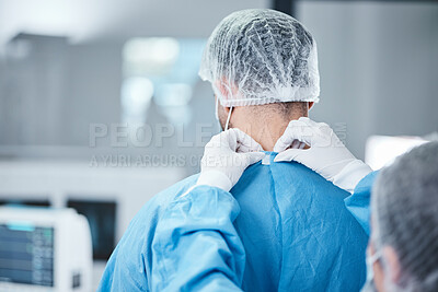 Buy stock photo Surgeon, scrubs and uniform to prepare for surgery, operation and and healthcare in medical theatre. Nurse, assistant and helping doctor with safety clothes in operating room, theatre and hospital