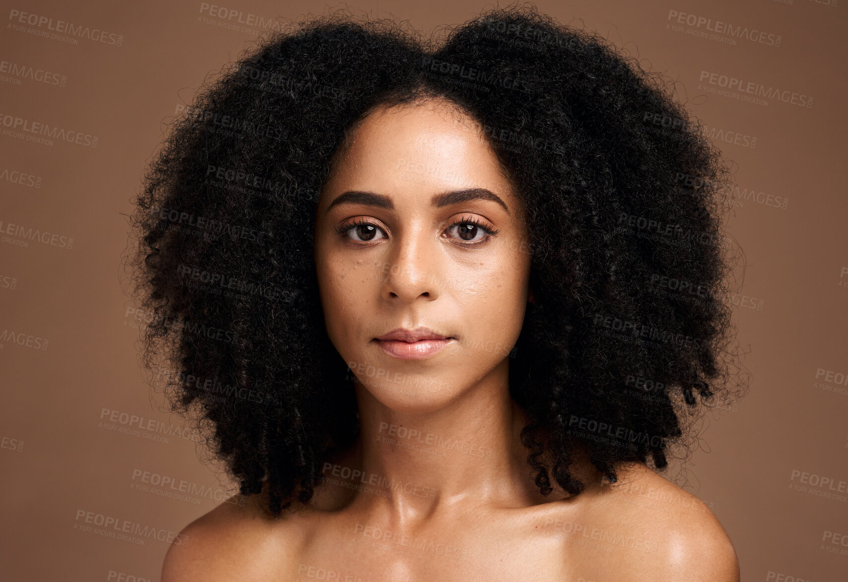 Buy stock photo Face, skincare and afro with a model black woman in studio on a brown background for natural beauty. Portrait, cosmetics and hair with an attractive young female posing to promote a cosmetic product