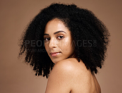 Buy stock photo Portrait, beauty and afro with a model black woman in studio on a brown background for natural skincare. Face, cosmetics and hair with an attractive young female posing to promote cosmetics