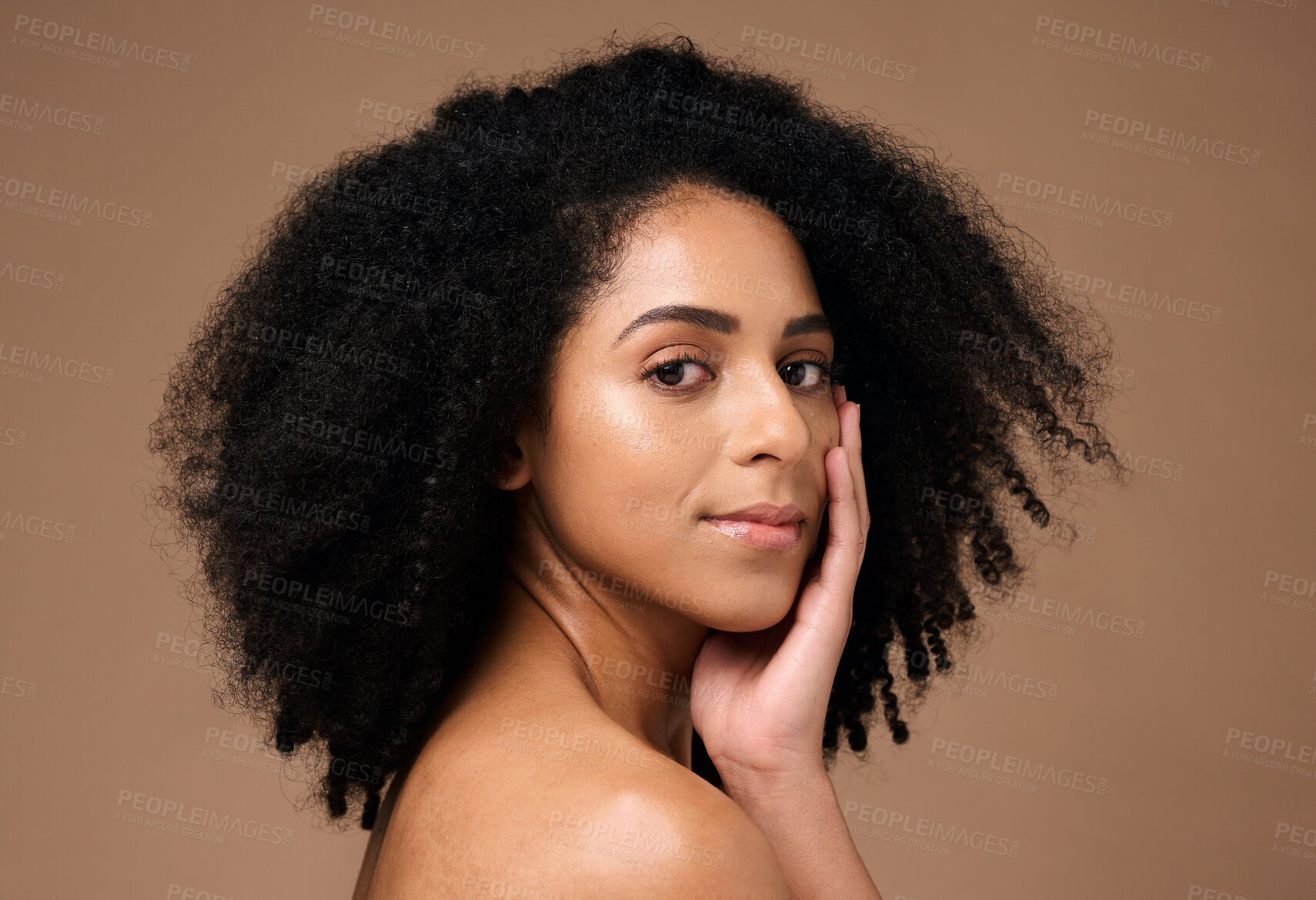Buy stock photo Portrait, beauty and afro with a model black woman in studio on a brown background for natural skincare. Face, cosmetics and hair with an attractive young female posing to promote cosmetics