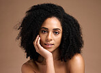 Black woman, studio portrait and beauty with skincare, cosmetic glow and thinking with afro by backdrop. Model, makeup and natural hair care for aesthetic, wellness and self care by brown backdrop