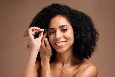 Buy stock photo Face, makeup and eyebrow pencil with a model black woman in studio on a brown background for a beauty product. Portrait, cosmetics and eyes with an attractive female inside to apply a cosmetic brand