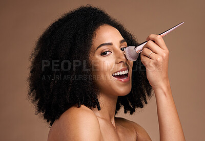 Buy stock photo Black woman, studio portrait and makeup brush for foundation, beauty and cosmetic self care by backdrop. Model, happy and powder on nose, face and smile for skincare glow by brown studio background