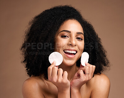 Buy stock photo Face portrait, skincare and black woman with cotton in studio isolated on a brown background. Wellness, cosmetics and happy female model holding facial pad or product for cleaning makeup for hygiene.