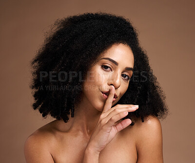 Buy stock photo Black woman, portrait and finger on lips for secret to skincare, cosmetics and body wellness on studio background. Face of female model with silence gesture on mouth for beauty, quiet and shush hands