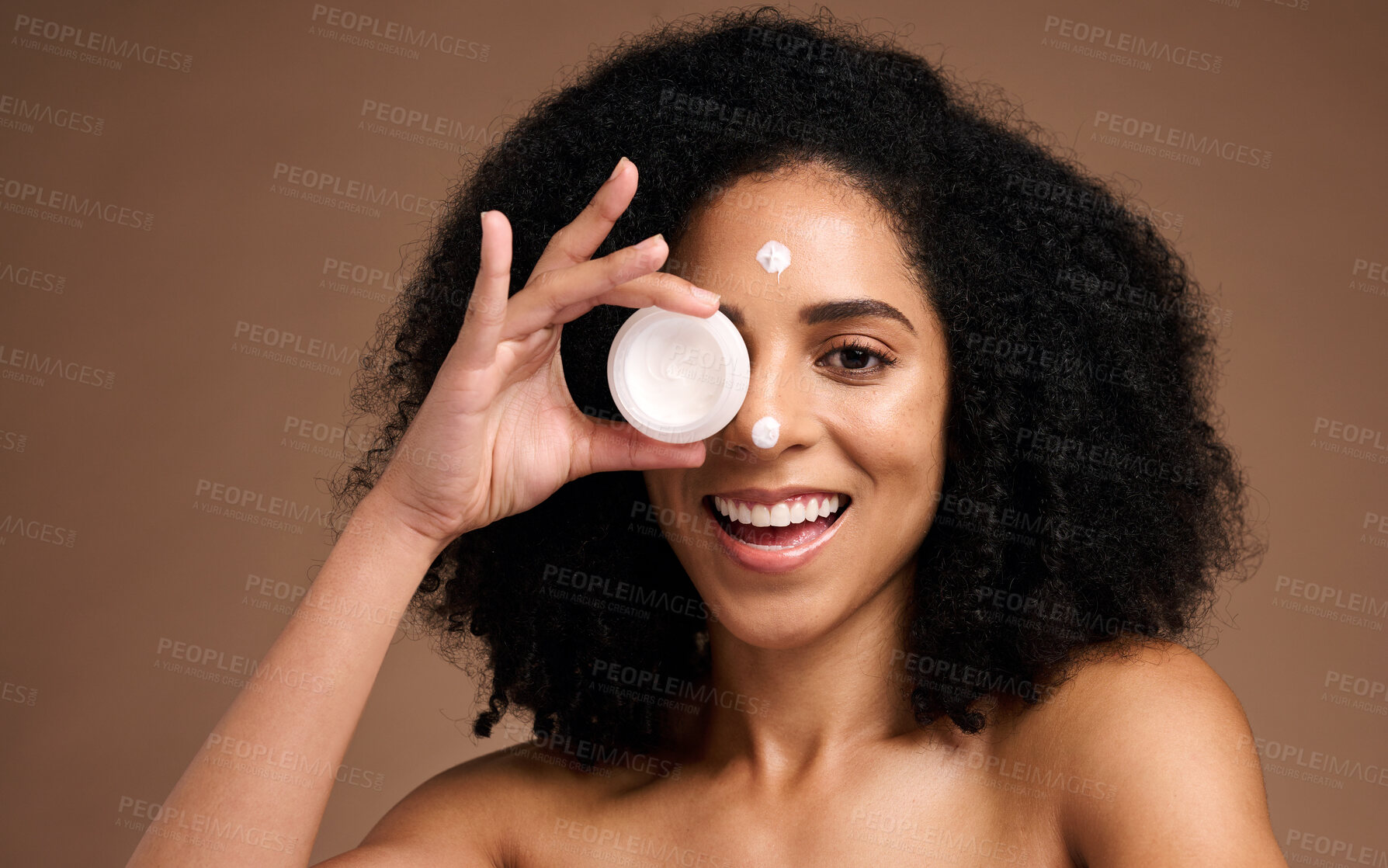 Buy stock photo Face, skincare and black woman with cream container in studio on a brown background. Makeup cosmetics, portrait and female model apply facial lotion, product or moisturizer creme for healthy skin.