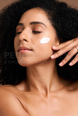 Buy stock photo Cosmetics, black woman and cream for organic facial collagen and brown studio background. Jamaican female, girl and face lotion for healthy, smooth or soft skin for spa treatment, self care or luxury